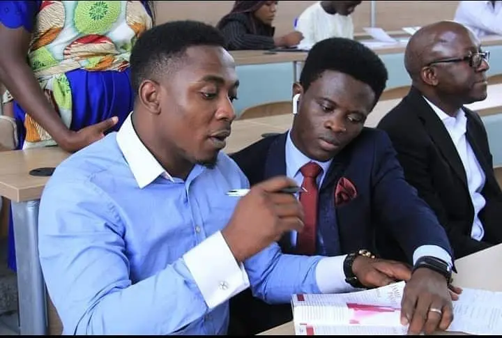 Taiwo Peace Oyeniyi operating a professional camera