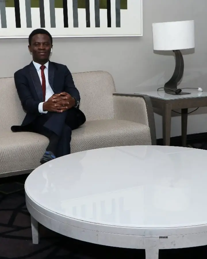 Taiwo Peace Oyeniyi seated during a work session