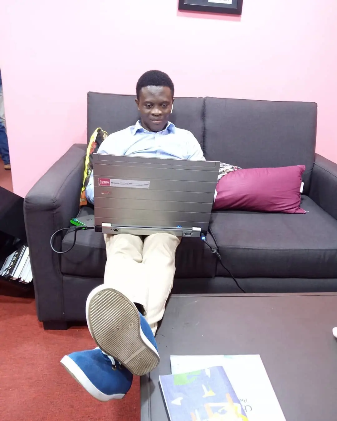 Taiwo Peace Oyeniyi working on a laptop