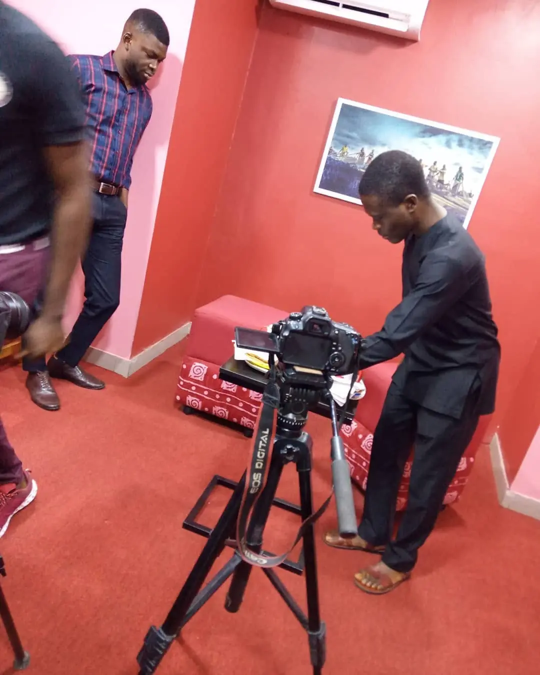 Taiwo Peace Oyeniyi preparing professional camera equipment