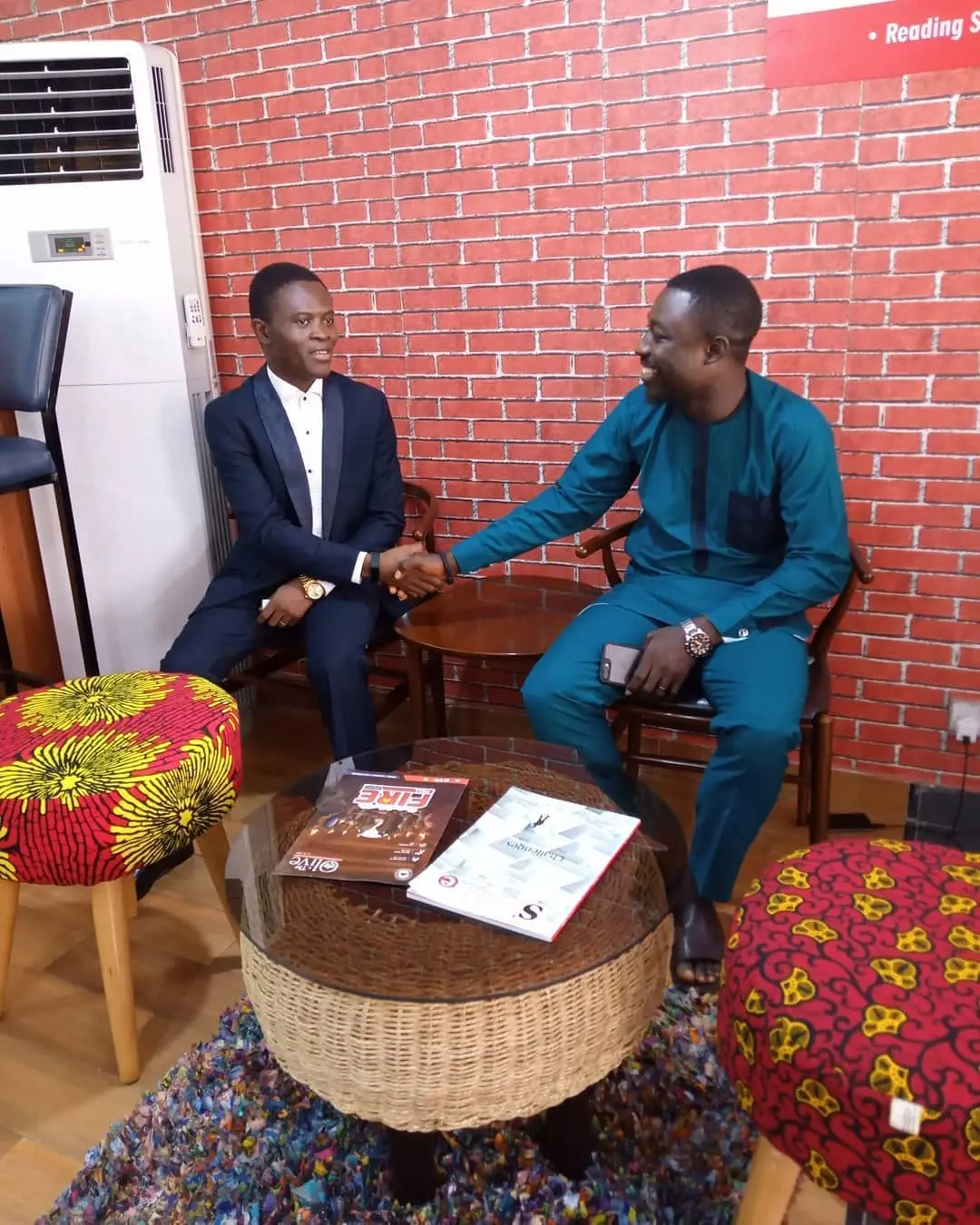 Taiwo Peace Oyeniyi greeting a guest during an interview