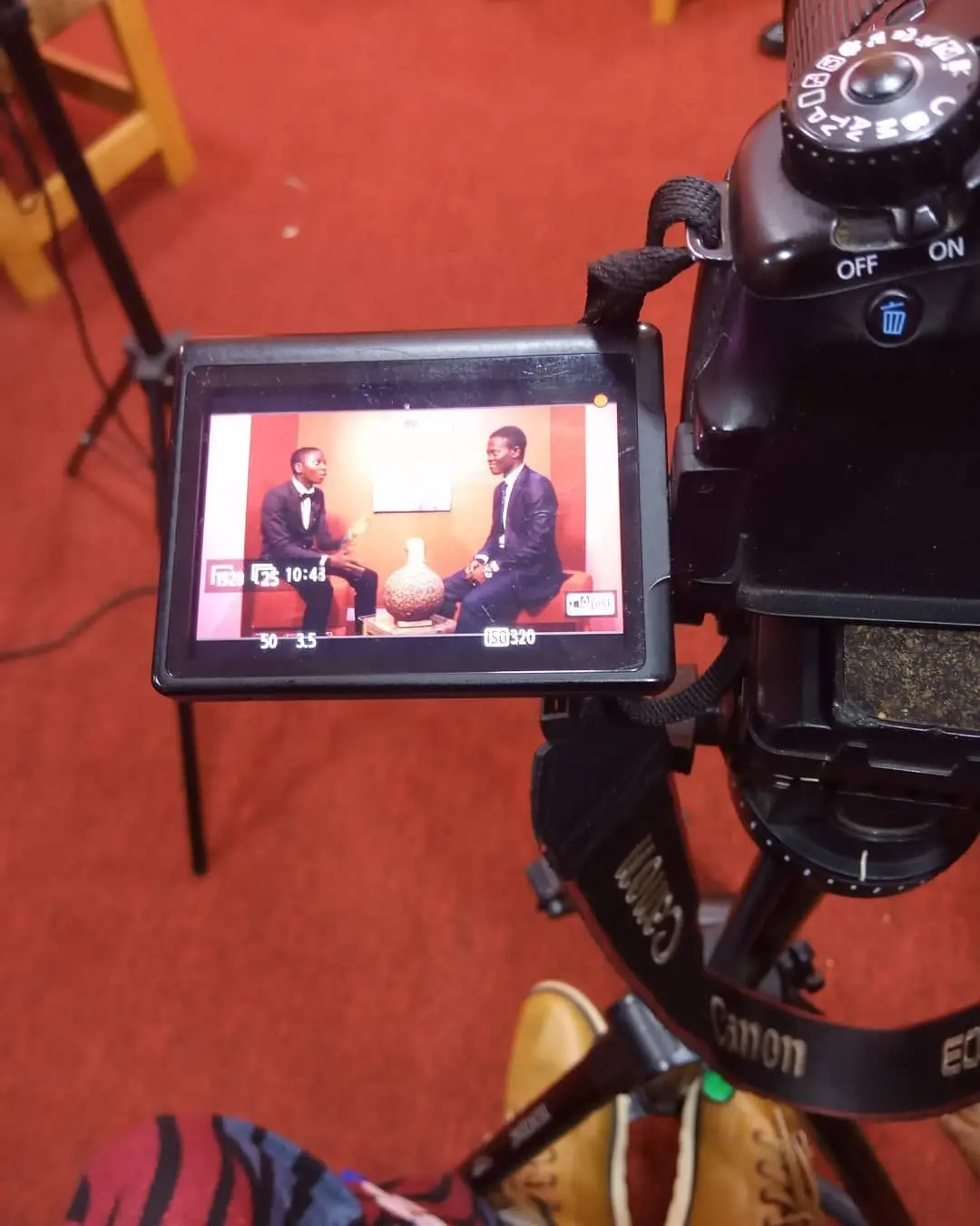Professional interview framed through a video camera monitor