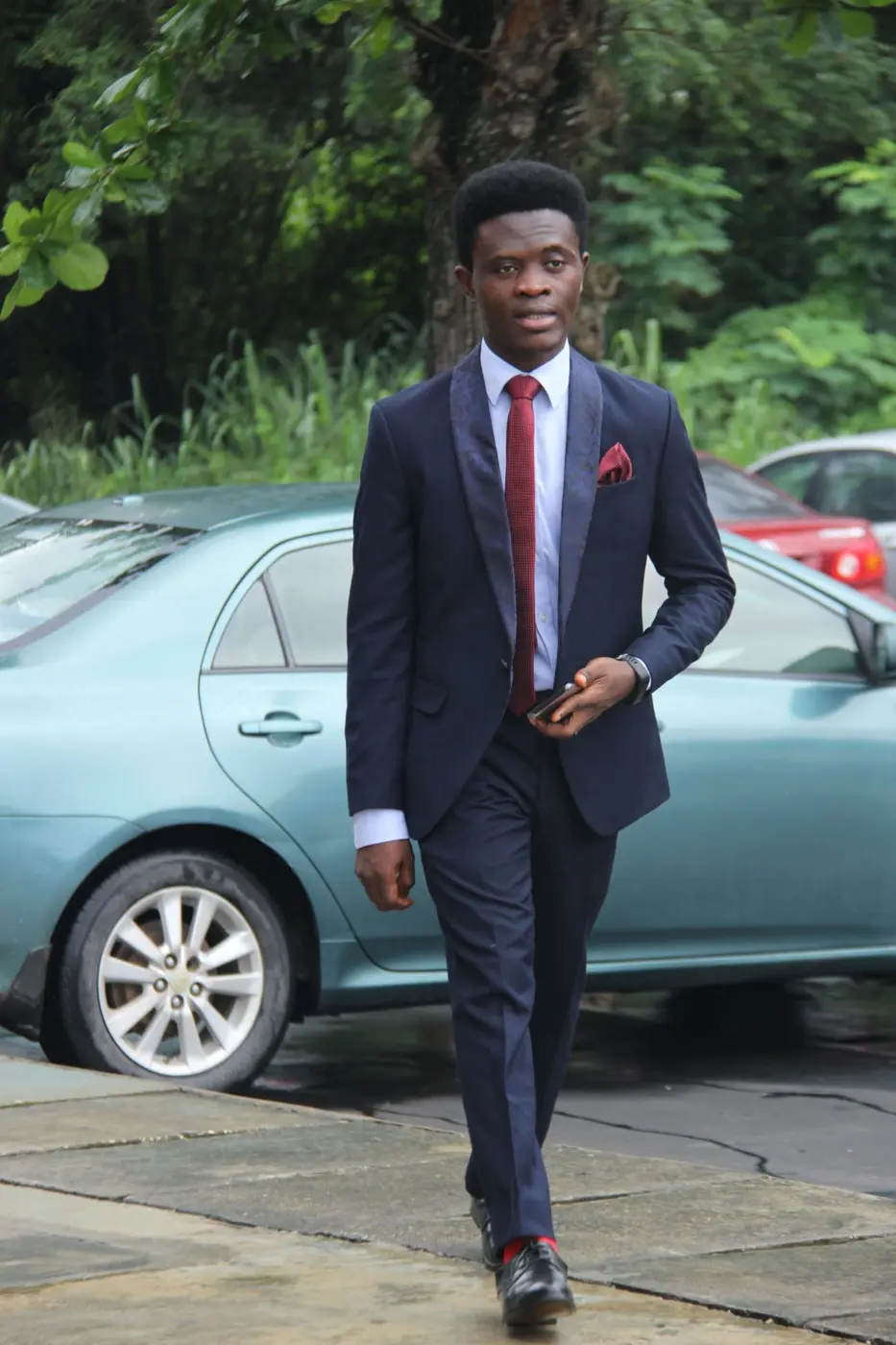 Taiwo Peace Oyeniyi in a full-length executive portrait
