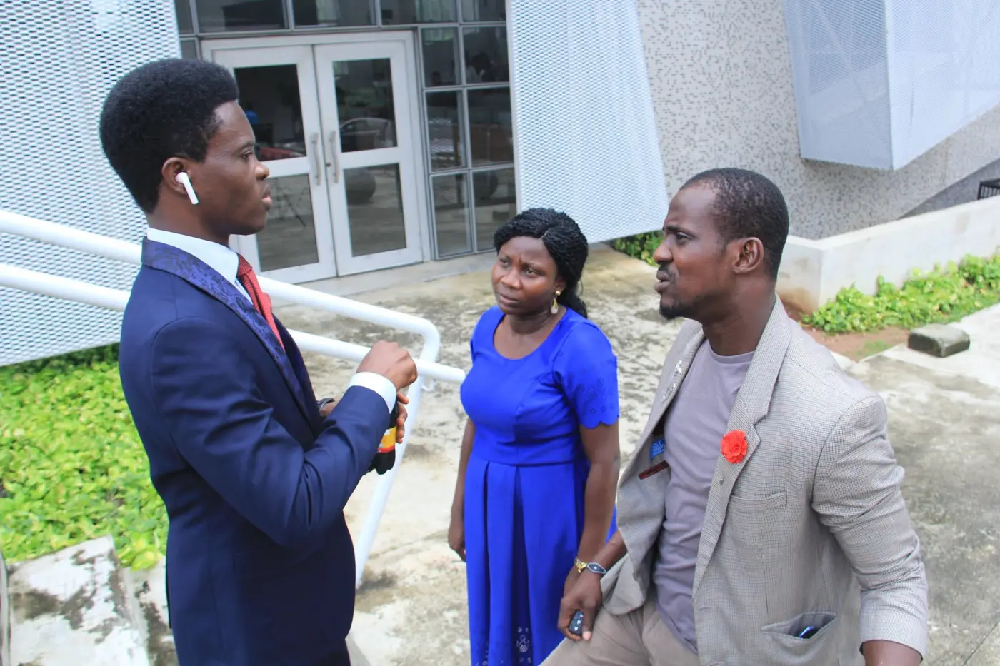 Taiwo Peace Oyeniyi speaking with guests outdoors