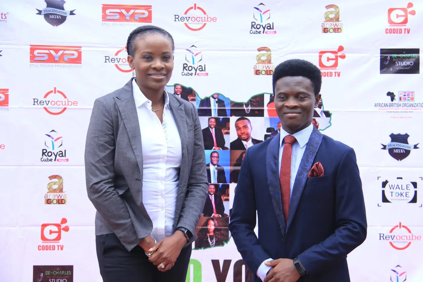 Taiwo Peace Oyeniyi with a professional guest before the event backdrop