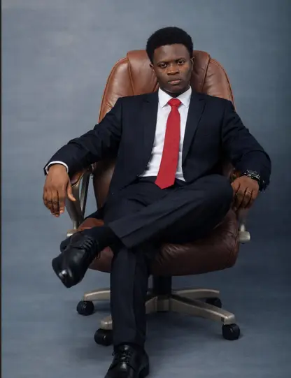 Taiwo Peace Oyeniyi seated in an executive portrait